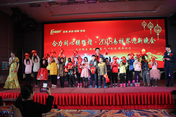 主持人為現(xiàn)場小朋友發(fā)放狗年吉祥物